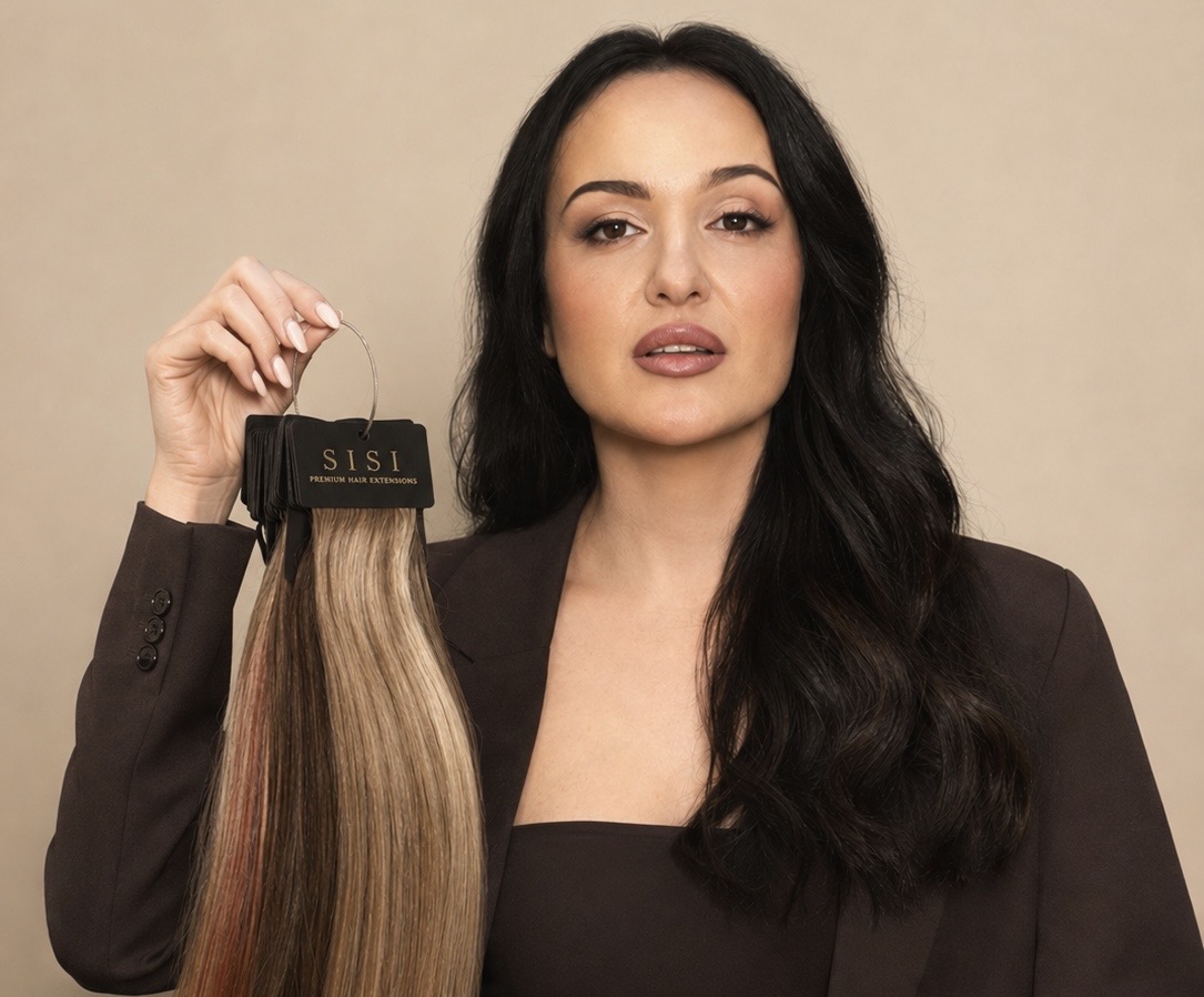 Stylist holding a SISI Premium Hair Extensions shade ring of dimensional lengths
